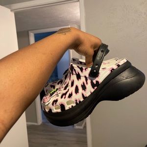 Cute cheetah crocs with charms .